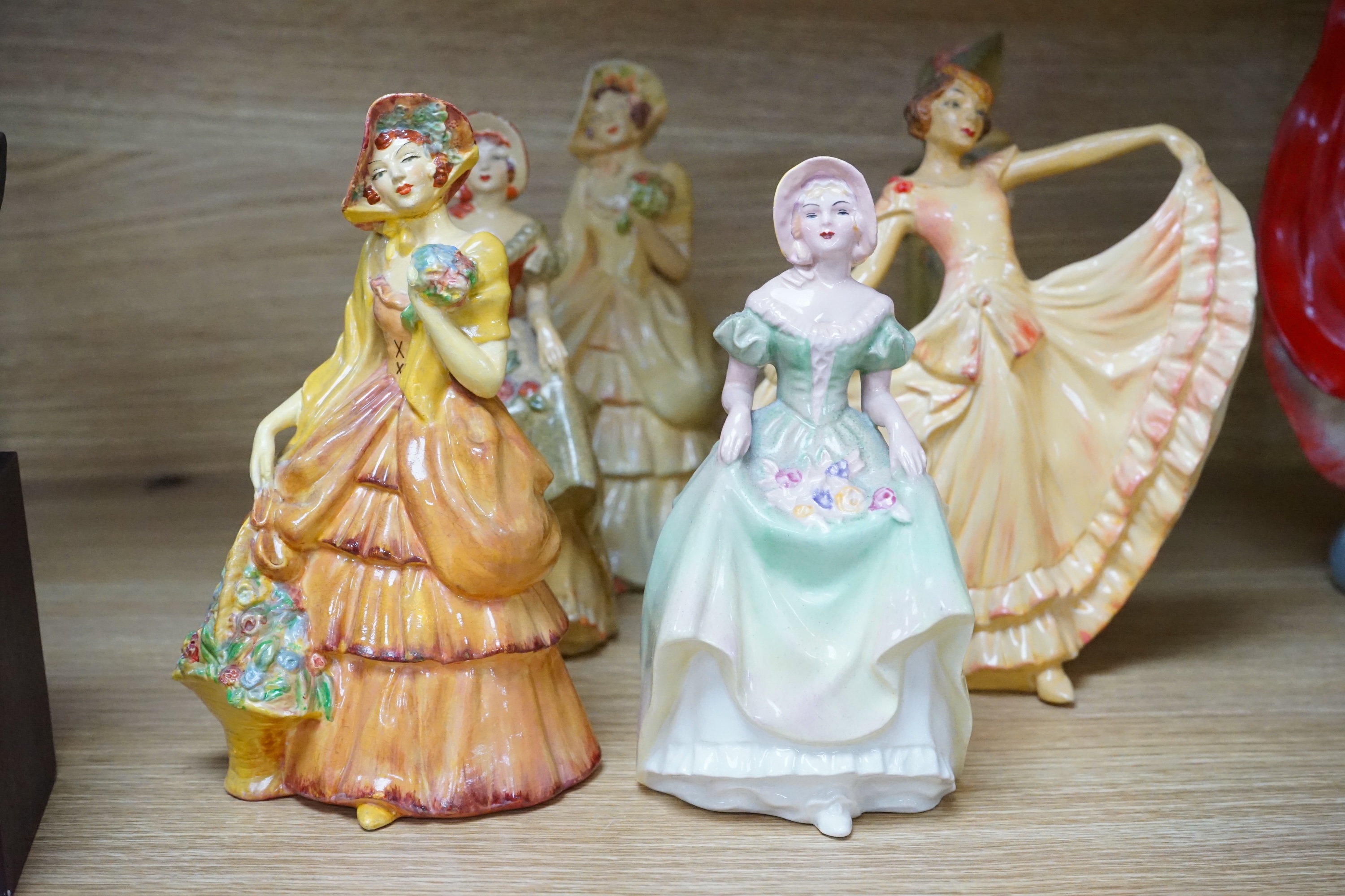 Nine Crown Devon 1930's dancers, in the manner of Wade figures, tallest 26cm high. Condition - fair to good